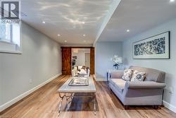 Living area with visible vents, recessed lighting, baseboards, and wood finished floors - 