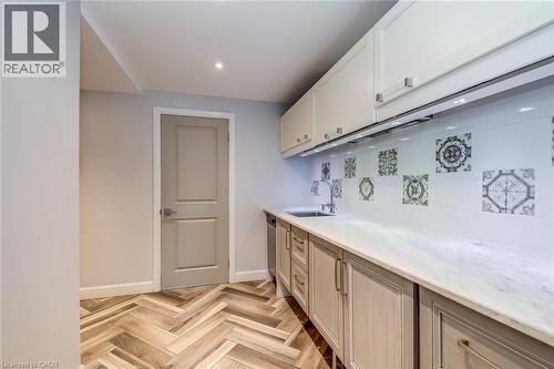 Kitchen featuring light stone countertops, baseboards, recessed lighting, a sink, and dishwasher - 4306 Lakeshore Road, Burlington, ON - Indoor
