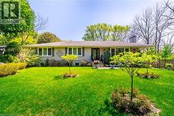 Ranch-style home with a chimney and a front yard - 