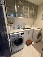Laundry area with cabinet space and washer and dryer - 