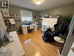 Office featuring light wood-type flooring and a sink - 