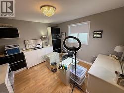 Home office featuring light wood-style floors and baseboards - 