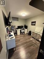 Office area with dark wood-style floors and baseboards - 