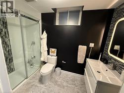 Bathroom with vanity, a stall shower, and decorative backsplash - 