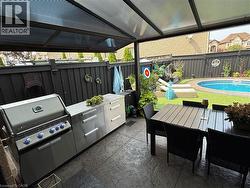 Fenced backyard featuring a patio area, outdoor dining area, and area for grilling - 