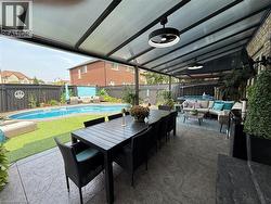 Fenced backyard with an outdoor living space, a patio area, a ceiling fan, and outdoor dining area - 