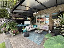 View of patio / terrace with an outdoor hangout area and a hot tub - 