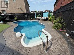 View of swimming pool with a fenced backyard, outdoor lounge area, and a patio - 