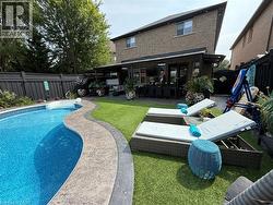 View of swimming pool featuring a fenced backyard, a patio area, and an outdoor living space - 