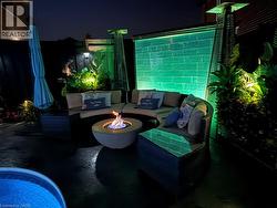 Patio at twilight with an outdoor living space with a fire pit and a patio - 