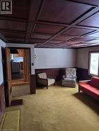 Living room with teak ceiling and wall panelling - 