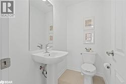 Bathroom featuring toilet and light tile patterned floors - 