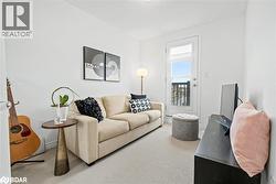 Living room featuring carpet floors and baseboards - 