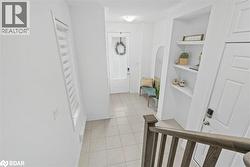 Corridor with light tile patterned floors and built in features - 