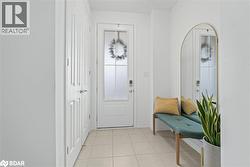 Entryway with light tile patterned floors and baseboards - 