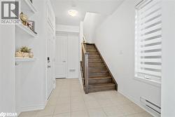 Staircase featuring baseboard heating and tile patterned floors - 