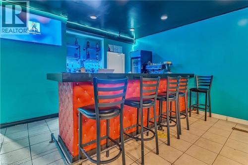 Indoor dry bar with dark countertops - 612 King Street E, Kitchener, ON 