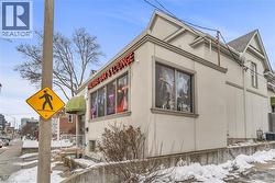 View of snow covered exterior featuring stucco siding and a cooling unit - 