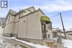 View of snow covered exterior with stucco siding - 