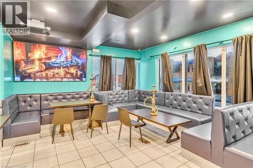 Home theater room featuring tile patterned flooring and recessed lighting - 612 King Street E, Kitchener, ON 