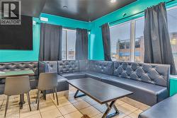 Living room featuring plenty of natural light and tile patterned flooring - 