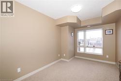 Unfurnished second bedroom with large windows and quality berber carpeting. - 