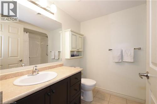 Bathroom with a large mirror above the vanity reflecting a premium quality acrylic tub/shower combination. - 645 St. David Street S Unit# 412, Fergus, ON - Indoor Photo Showing Bathroom