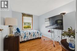 Bedroom with light wood-style floors and baseboards - 