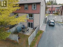 Back of house featuring a patio area, stairway, and brick siding - 