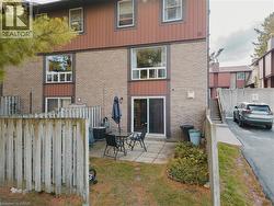 Back of house with a patio, brick siding, and stairs - 