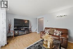 Living room featuring stairway and wood finished floors - 