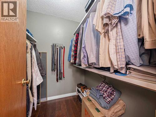 Primary Bedroom Walk-In Closet - 301 Arbour Cliff Close Nw, Calgary, AB - Indoor With Storage