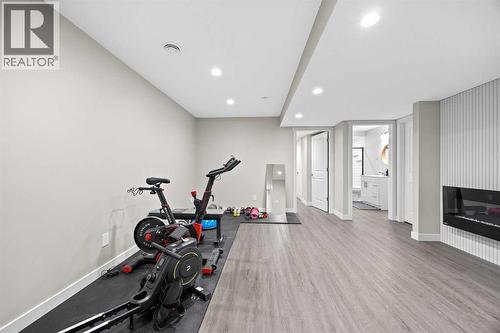 Basement Living Room - 80 Wolf Gate, Okotoks, AB - Indoor Photo Showing Gym Room