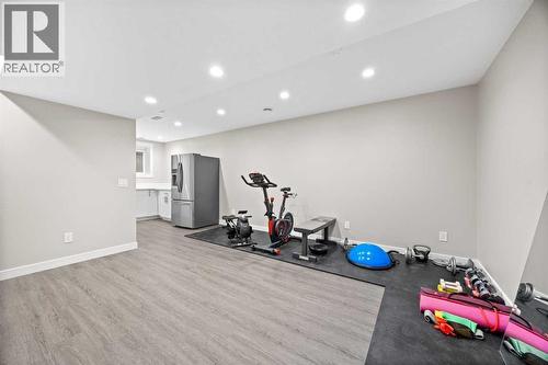 Basement Living Room - 80 Wolf Gate, Okotoks, AB - Indoor Photo Showing Gym Room