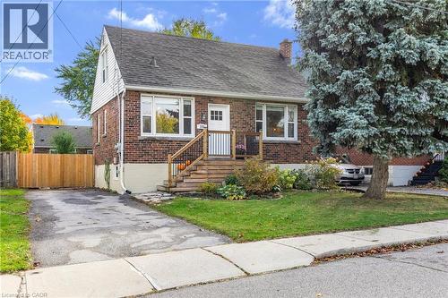 View of front of house featuring brick siding, a chimney, and roof with shingles - 191 East 11Th Street, Hamilton, ON - Outdoor