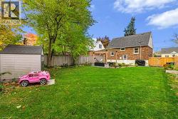 Fenced backyard with a shed and a patio - 