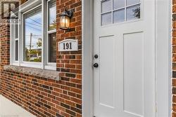 View of exterior entry featuring brick siding - 