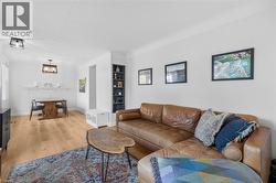 Living area featuring light wood-style floors and baseboards - 