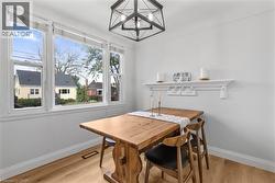 Dining area with light wood-style flooring and a chandelier - 