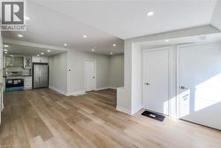 recessed lighting and light wood-style flooring - 