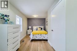 Bedroom featuring light wood-style flooring and baseboards - 
