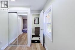 Hall featuring light wood-style floors and baseboards - 