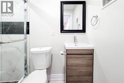 Bathroom with vanity and a marble finish shower - 