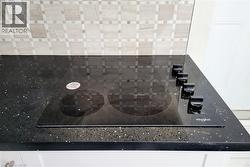 Kitchen view of black electric cooktop - 