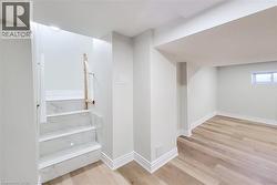 Staircase with baseboards and wood finished floors - 