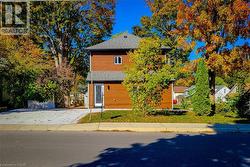 View of front of property featuring a shingled roof - 