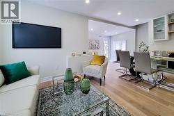 Living room featuring light wood-style floors and recessed lighting - 