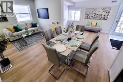 Dining space featuring wood finished floors and baseboards - 