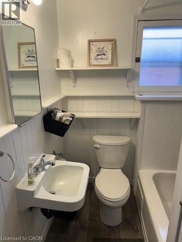 Bathroom with a wainscoted wall, dark wood-style floors, and a tub to relax in - 37 Dundas Street, Dundas, ON - Indoor Photo Showing Bathroom