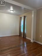 Empty room with dark wood-style floors and baseboards - 